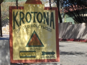 Krotona Apts. Sign with parking lot in background. Photo by Hope Anderson Productions
